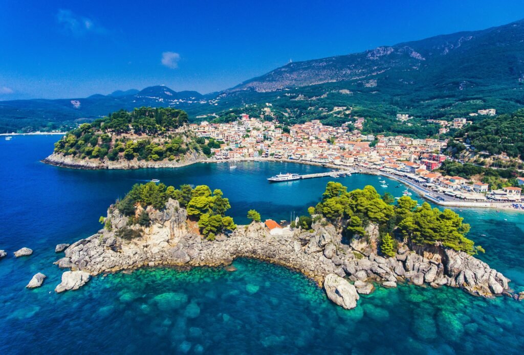 Charming coastal village in Greece with crystal clear waters and traditional homes, an ideal island living destination for US military retirees living overseas seeking affordable retirement and a relaxed lifestyle.