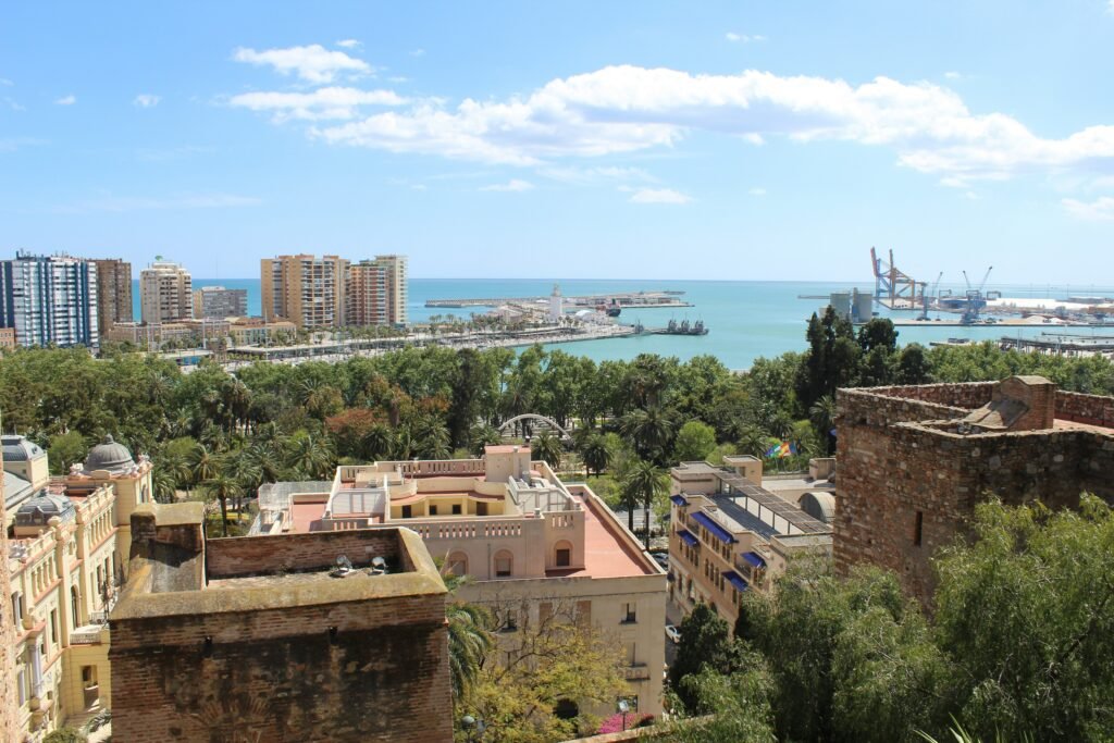 A stunning aerial shot of Málaga’s coastline, showing Playa de la Malagueta, palm-lined streets, and the vibrant mix of city and beach life.