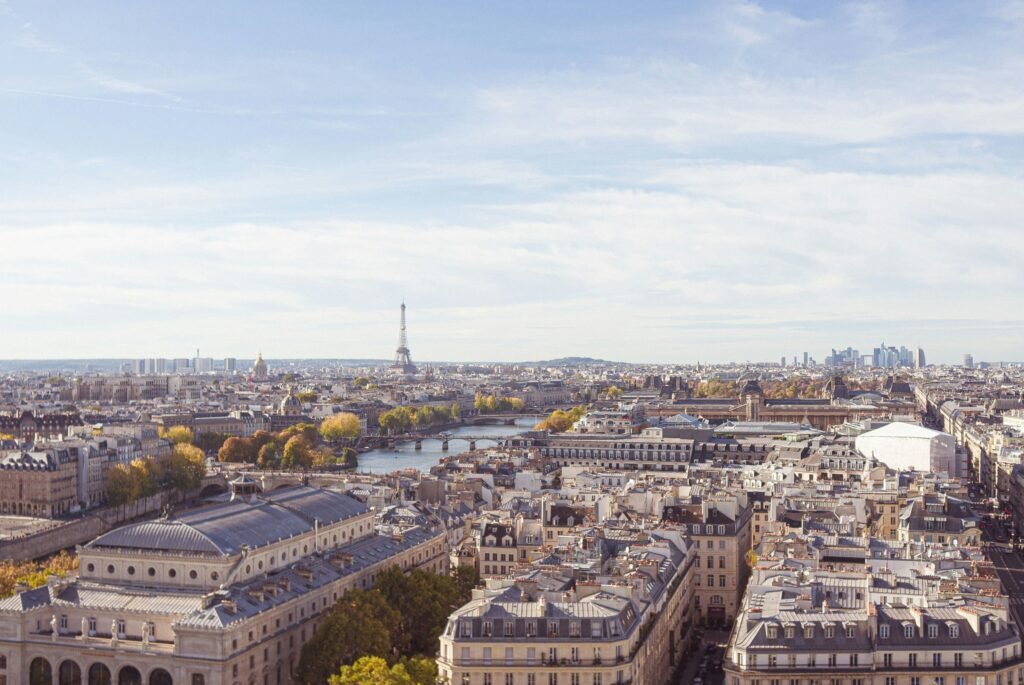 Panoramic view of Paris featuring the Eiffel Tower, showcasing vibrant city life and culture, an attractive destination for US military retirees living overseas who desire top-tier healthcare and urban living.