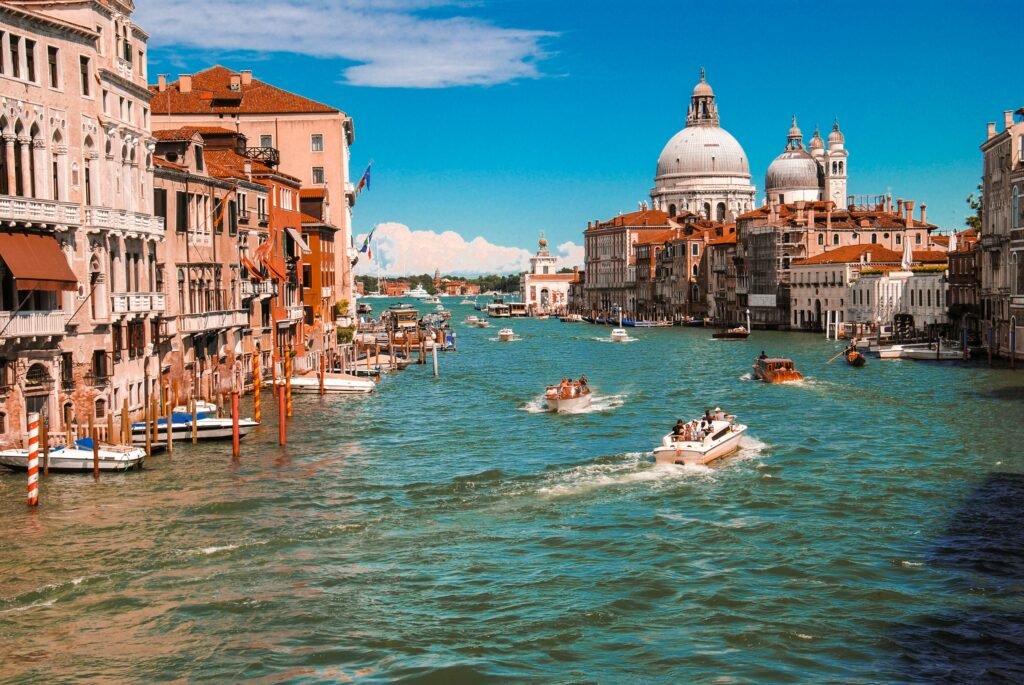 Scenic canals of Venice, Italy with boats drifting through historic waterways, a dream destination for US military retirees living overseas who value rich culture, history, and a relaxed retirement lifestyle.