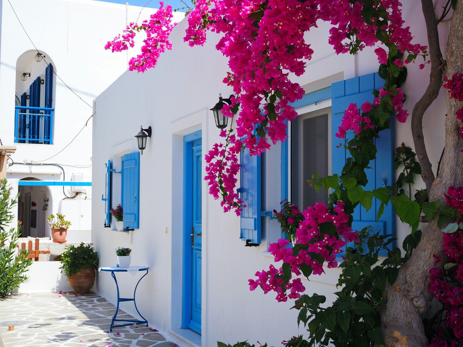 Traditional Greek architecture with whitewashed buildings and vibrant blue shutters, showcasing Greece.